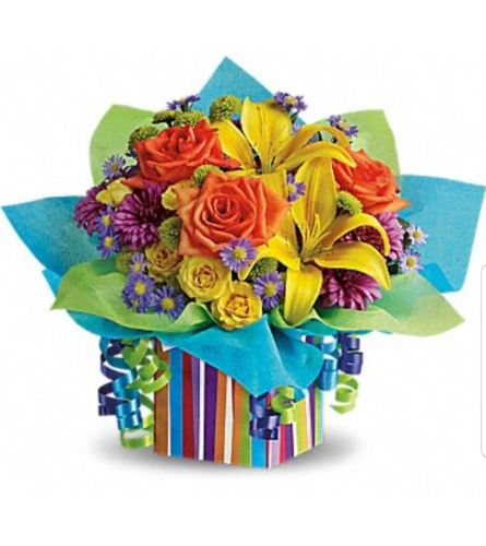 RAINBOW PRESENTS. An arrangement by Avenue Flowers and Gifts.