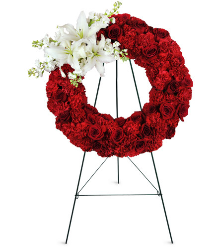 Love's Remembrance Wreath™. An arrangement by Avenue Flowers and Gifts. Beautiful roses blooms, carnations, Asiatic lilies, and more are arranged...