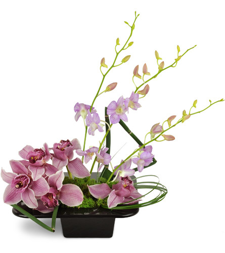 Shanghai Dusk Orchids™. An arrangement by Avenue Flowers and Gifts. Pink Cymbidium orchids and tall lavender Dendrobium orchids are arranged with...