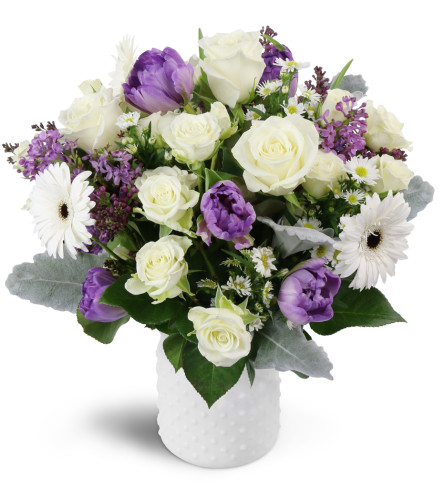 Oasis in Bloom™ - Deluxe. An arrangement by Avenue Flowers and Gifts. Featuring white spray roses, purple tulips, and more..