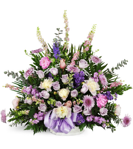 Love's Twilight Sympathy Basket™ - Deluxe. An arrangement by Avenue Flowers and Gifts. Larkspur, mums, and peonies are arranged with seasonal...