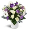 Oasis in Bloom™ - Standard. An arrangement by Avenue Flowers and Gifts. Featuring white spray roses, purple tulips, and more..