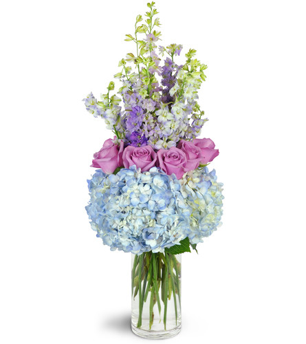 Evening in Versailles™. An arrangement by Avenue Flowers and Gifts. Lavender roses and larkspur are artistically arranged with hydrangea in a...