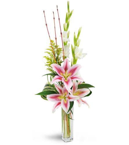 Starry Romance™. An arrangement by Avenue Flowers and Gifts. Oriental lilies, gladiolus, solidago, lush tropical leaves, and more are arranged in...