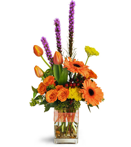 Soaring Autumn™. An arrangement by Avenue Flowers and Gifts. Tulips, Gerbera daisies, spray roses, and more are tied with an orange bow..