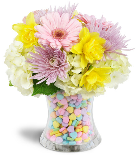 Sweet Candy Dreams™. An arrangement by Avenue Flowers and Gifts. Gift them Gerbera daisies, daffodils, and more arranged in a double-walled vase...