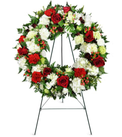 Passionate Faith Sympathy Wreath™. An arrangement by Avenue Flowers and Gifts.
