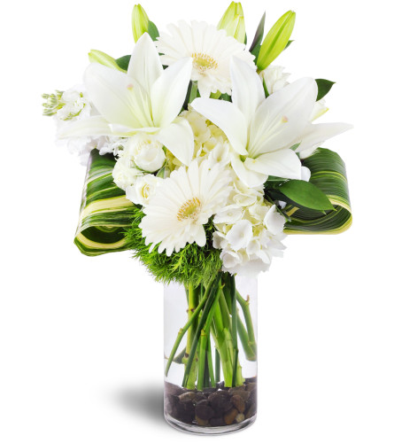 Inspired Blooms™ - Deluxe. An arrangement by Avenue Flowers and Gifts. White lilies, white hydrangea, and white spray roses are accented with...