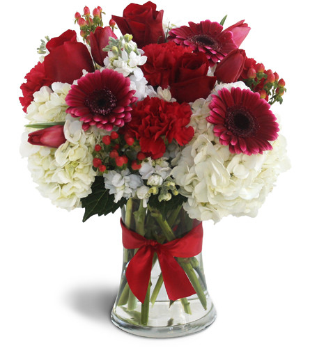 Visions in Red. An arrangement by Avenue Flowers and Gifts. Red Gerbera daisies, red roses, red carnations, white hydrangeas, and hypericum...