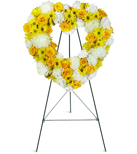 Love is Golden Heart™. An arrangement by Avenue Flowers and Gifts. Yellow roses, strikingly large mums, carnations, and daisies are sweetly...