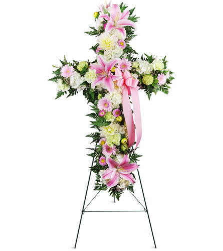 Stargazer Sympathies Cross™. An arrangement by Avenue Flowers and Gifts. Stargazer lilies, dahlias, and Gerbera daisies are arranged for display...