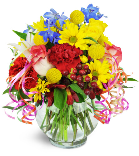 Celebrating You!™ - Deluxe. An arrangement by Avenue Flowers and Gifts. Roses, carnations, lilies, and more are arranged in a glass vase..