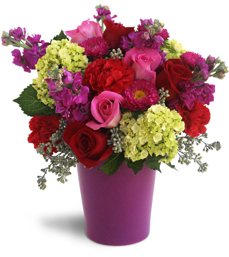 Bursting with Blooms™. An arrangement by Avenue Flowers and Gifts. Pink roses, red roses, red carnations, purple phlox, green hydrangeas, and...