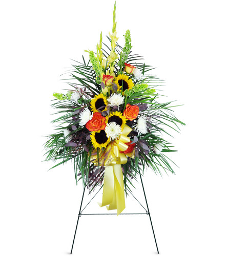 Wildflower Garden Tribute™. An arrangement by Avenue Flowers and Gifts. Sunflowers, roses, and more in earthy shades of yellow, orange, and green....