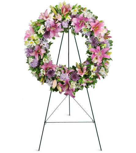 Encircled By Love™. An arrangement by Avenue Flowers and Gifts. Lilies, mums, larkspur, and more are gracefully arranged for display at the...
