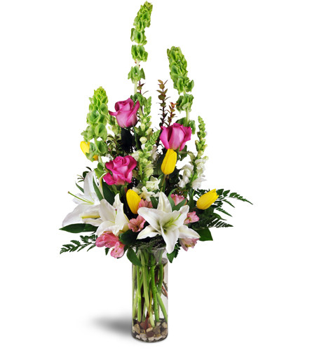 Sweetest Day Surprise™. An arrangement by Avenue Flowers and Gifts. Fuchsia roses, white Oriental lilies, yellow tulips, pink alstroemeria, and...