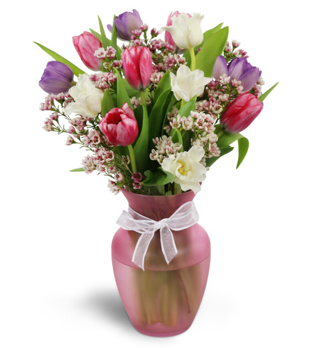 Home Sweet Spring™ - Deluxe. An arrangement by Avenue Flowers and Gifts. Colorful tulips and waxflower are arranged in a pretty glass vase..