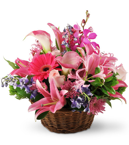 Hearts And Flowers. An arrangement by Avenue Flowers and Gifts. This elegant basket overflows with Asiatic lilies, roses, delphinium, Mokara...