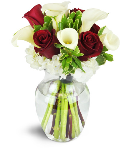 Spoiled Sweet!™. An arrangement by Avenue Flowers and Gifts. Red roses and white calla lilies are tastefully arranged in a classic rose vase..