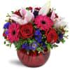 Forever Smitten™ - Deluxe. An arrangement by Avenue Flowers and Gifts. Fuchsia mini Gerbera daisies are romantically arranged with red roses,...