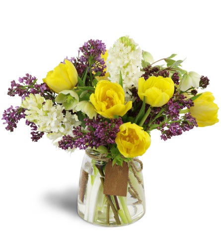 With Tulips on Top™ - Deluxe. An arrangement by Avenue Flowers and Gifts. Sunny yellow tulips and fragrant lilacs and hyacinth are arranged in...
