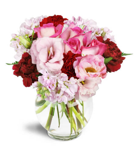 Joyful Heart™ - Deluxe. An arrangement by Avenue Flowers and Gifts. Bring joy to all with pink roses, lisianthus, stock, and red carnations..