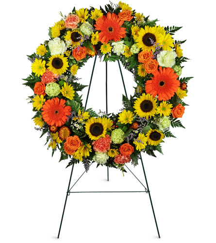 Heavenly Dawn Sunflower Wreath™. An arrangement by Avenue Flowers and Gifts. Sunflowers, Gerbera daisies, roses, and carnations are arranged for...