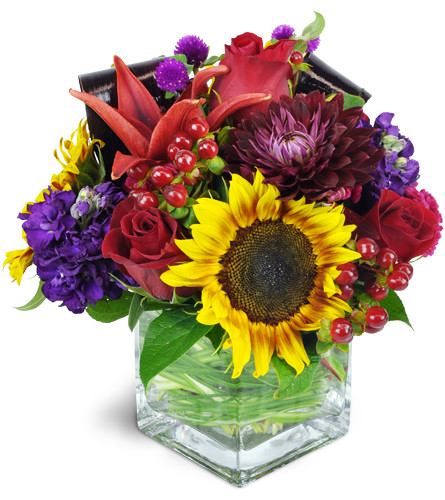 Market Fresh Blooms™. An arrangement by Avenue Flowers and Gifts. Summery sunflowers, roses, lilies, and more are arranged in a glass vase..
