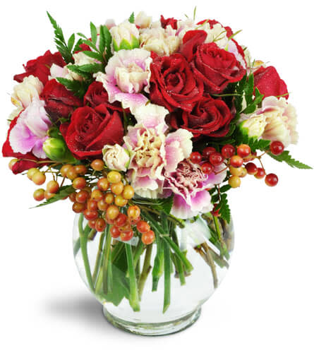 Sweetness and Romance™. An arrangement by Avenue Flowers and Gifts. Lush red spray roses, pink and white bicolor mini carnations, and more are...