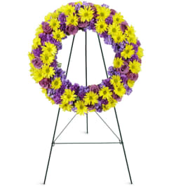 Sunrise Daisy Wreath™. An arrangement by Avenue Flowers and Gifts.