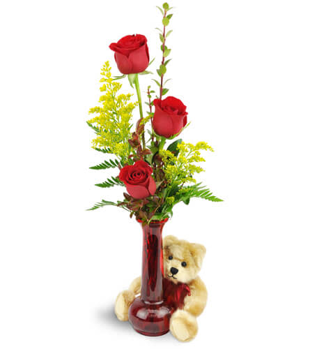 Rose Trio™ with Plush Bear. An arrangement by Avenue Flowers and Gifts. Three red roses are arranged with greenery and encircled by a beige plush...