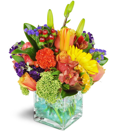 Splash of Laughter!™. An arrangement by Avenue Flowers and Gifts. Roses, lilies, alstroemeria, and more are arranged in a modern glass cube..