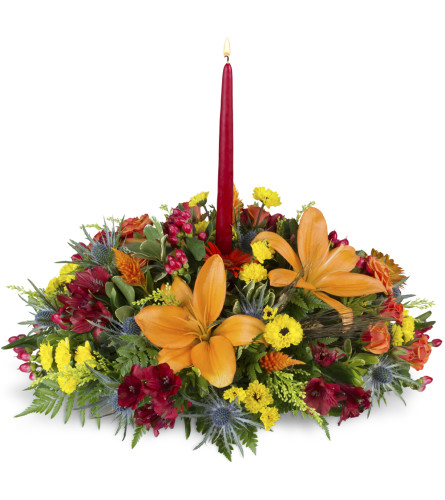 Warm and Wonderful Centerpiece™. An arrangement by Avenue Flowers and Gifts. Finish your holiday table with a centerpiece of bright orange lilies,...