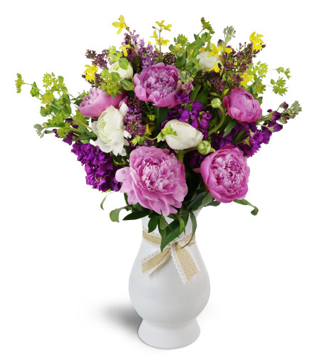 Wild at Heart™ - Deluxe. An arrangement by Avenue Flowers and Gifts. Peonies, ranunculus, and more are arranged in a glass vase..