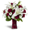 Full of Love™ - Premium. An arrangement by Avenue Flowers and Gifts. Classic red roses and mini Calla lilies are elegantly arranged in a glass...